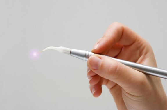 Person holding a dental soft tissue laser
