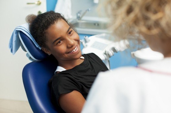 Young girl smiling at her dentist