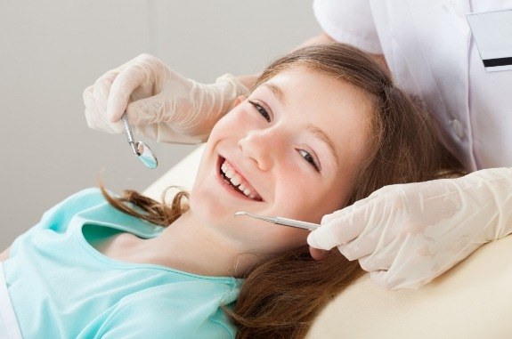 Girl smiling right before her dental exam