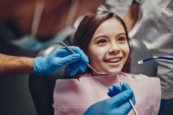 Young girl smiling while visiting her children's dentist