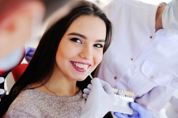 Woman trying on veneers from her cosmetic dentist in Clute