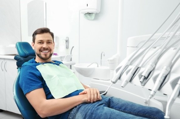 Smiling man laying back in dental chair