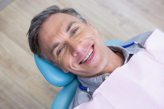 Smiling older man in dental chair