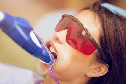 Girl receiving fluoride treatment in dental office