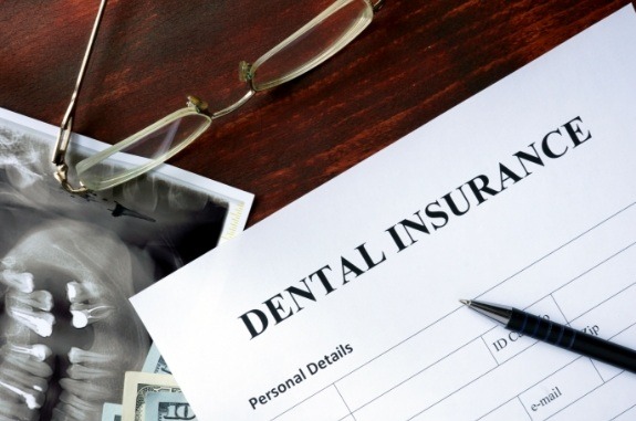 Dental insurance form on wooden table