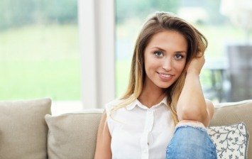 Blonde woman sitting on couch