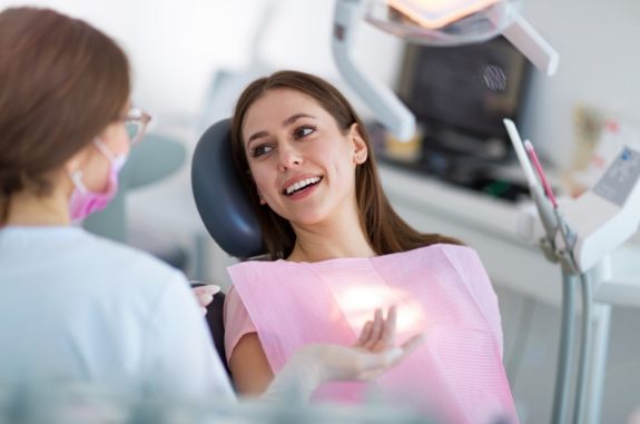 Young woman smiling at her dentist