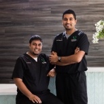 Two Clute dentists smiling in reception area of Woodshore Family Dentistry