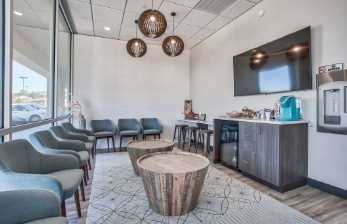 Chairs and refreshment station in reception area of Woodshore Family Dentistry