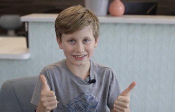 Dental patient Isaac giving thumbs up