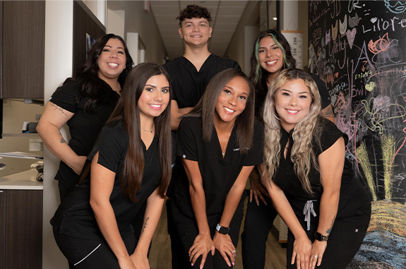 The smiling Clute dentists and team at Woodshore Family Dentistry
