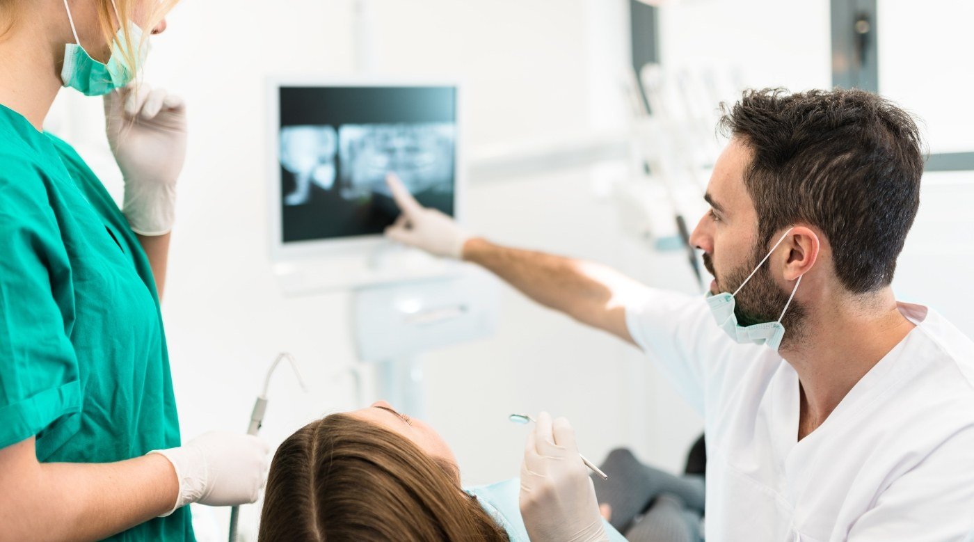 Dentist showing a patient their dental x rays