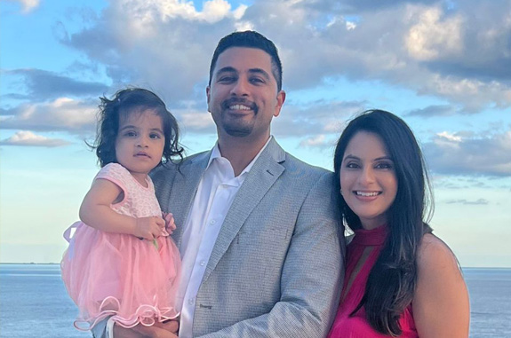 Clute Texas dentist Doctor Vishal Pattni on the beach with his wife and child