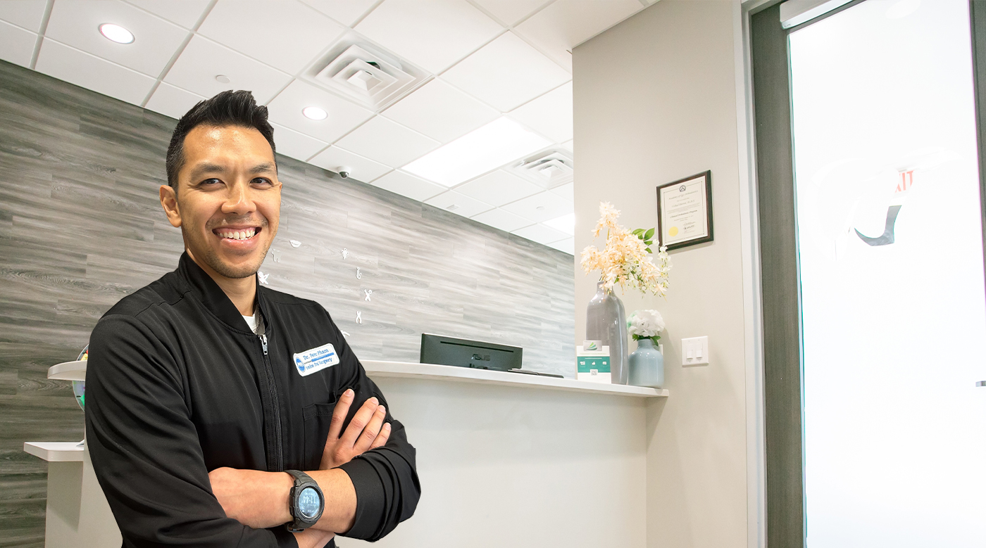 Clute Texas dentist Doctor Peter Pham smiling in dental office waiting room