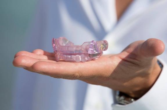 Dentist holding a mouthguard for teeth grinding