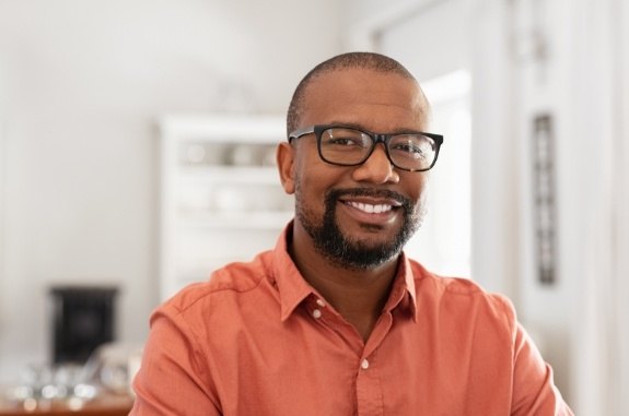 Smiling man in orange button up shirt