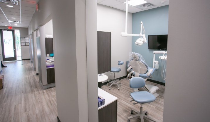 Dental treatment room viewed from dental office hallway
