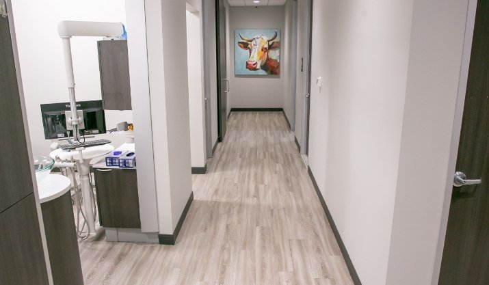 Dental office hallway with painting of longhorn on wall at the end