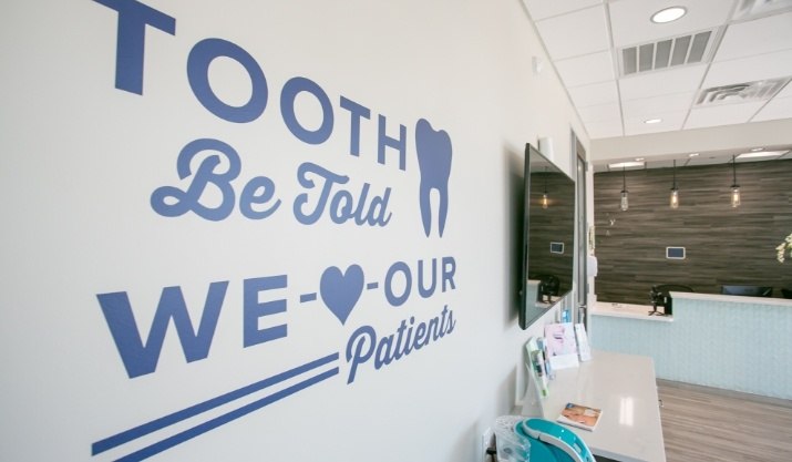 Mural on waiting room wall reading tooth be told we heart our patients