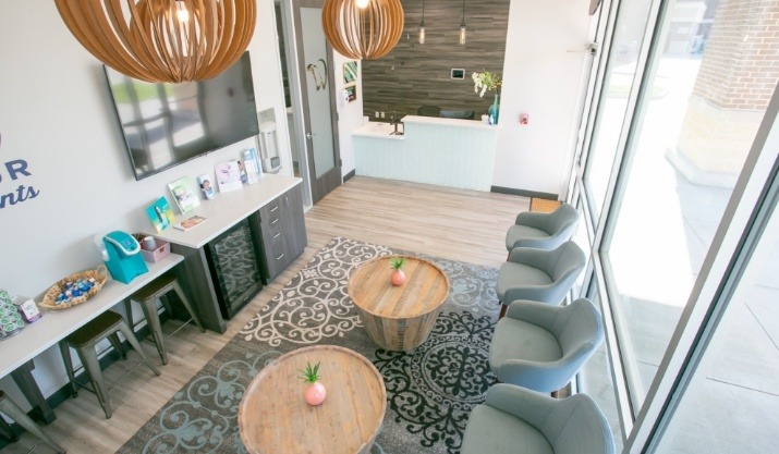 Slightly zoomed out view of two small tables in dental office waiting room