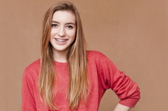 Smiling teenage girl with braces in Clute