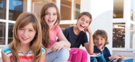Four children sitting on porch