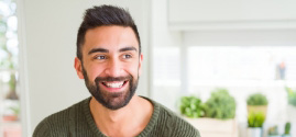Smiling man wearing green sweaeter