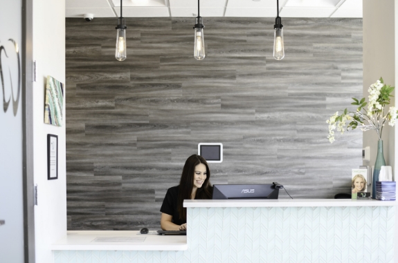 Dental team member sitting at front desk