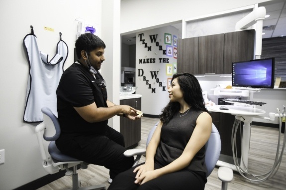 Woman talking to her dentist about preventive dentistry in Clute