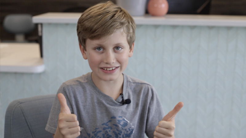 Dental patient Isaac giving thumbs up