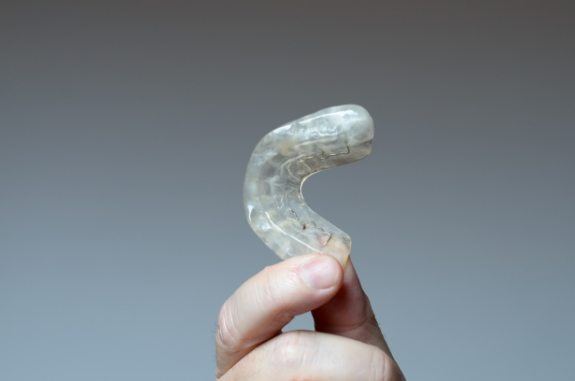 Person holding a dental nightguard in their hand