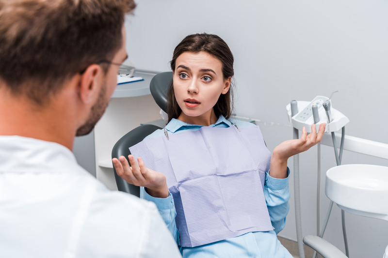 Patient asking dentist about Invisalign versus traditional braces