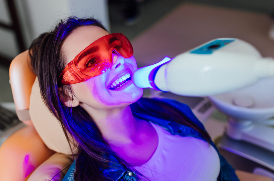 Woman getting teeth whitening treatment